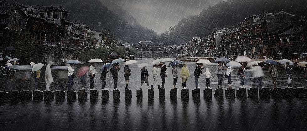 "Rain in an Ancient Town", photo taken in Phoenix town in China showing people traveling during the rainy season