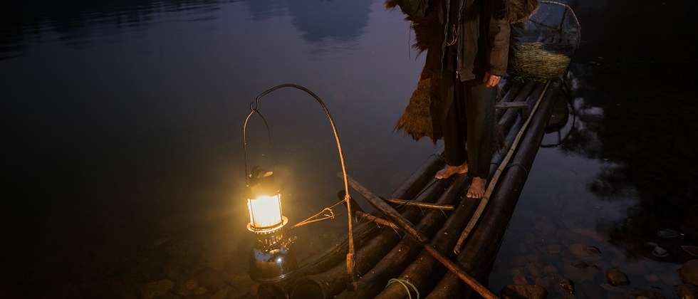 "Going Home", On the Li River near Xingping in China, Cormorant fishermen work the waterways before dawn amidst the spectacular limestone towers of the Karst landscape.  The birds are trained to fetch fish from the inky depths but not swallow them.  The f (© Neville Jones, Australia, 1st Place National Award, 2014 Sony World Photography Awards)