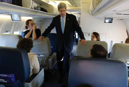 US Secretary of State John Kerry talks to the media aboard his plane as he departs the United States on his way to Geneva, Switzerland, for high-stakes talks on Ukraine April 16, 2014 Jim Bourg (Pool/AFP)