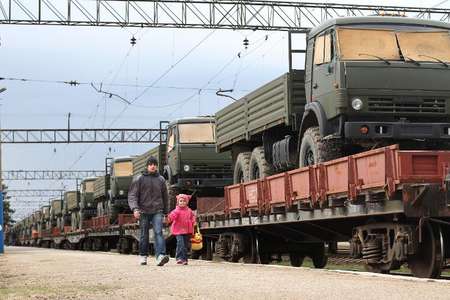 Children walk past a trainload of KAMAZ Russian military trucks after their arrival at Ostryakovo railway station, some 20 km outside near the Crimean capital Simferopol, on April 1, 2014 Yuriy Lashov (AFP)