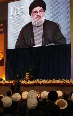Lebanese supporters of the Shiite Hezbollah movement watch its chief Hassan Nasrallah, giving a televised speech in Beirut on December 20, 2013 Anwar Amro (AFP)